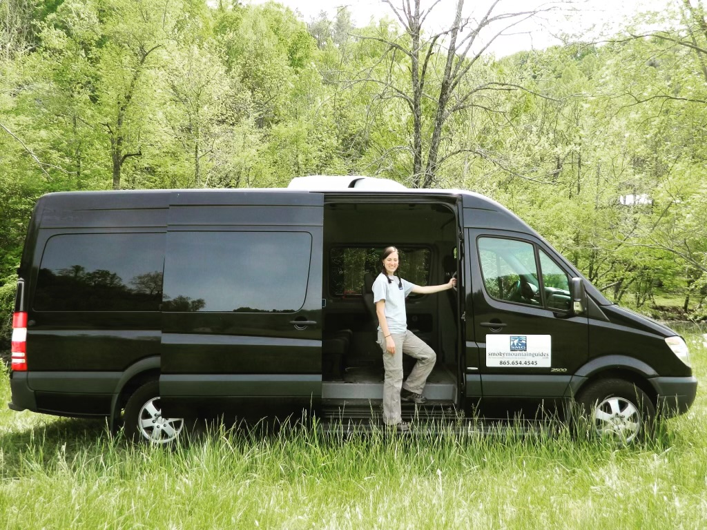 Woman standing in door of large sprinter van. Auto tour. Smoky Mountain Guides